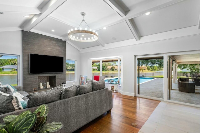 living room with high vaulted ceiling, beamed ceiling, baseboards, wood finished floors, and a notable chandelier