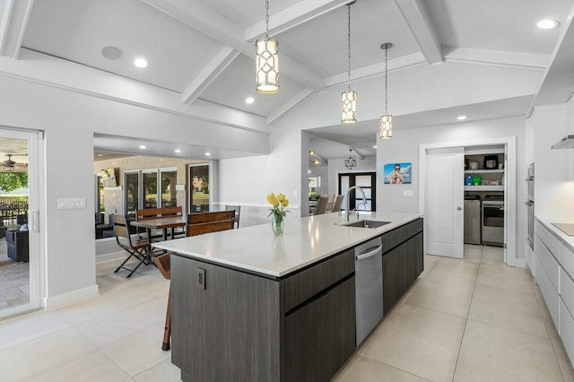 kitchen with a sink, lofted ceiling with beams, dishwasher, modern cabinets, and a large island