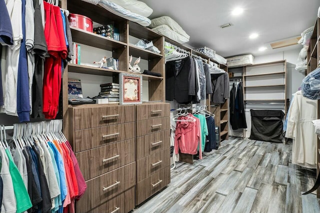 walk in closet with visible vents and wood finished floors