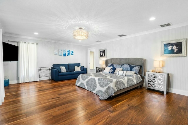 bedroom featuring baseboards, ornamental molding, visible vents, and wood finished floors