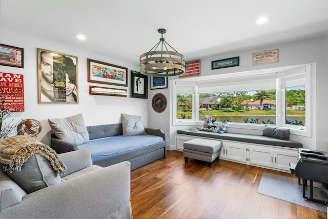 living area featuring wood-type flooring, an inviting chandelier, and recessed lighting