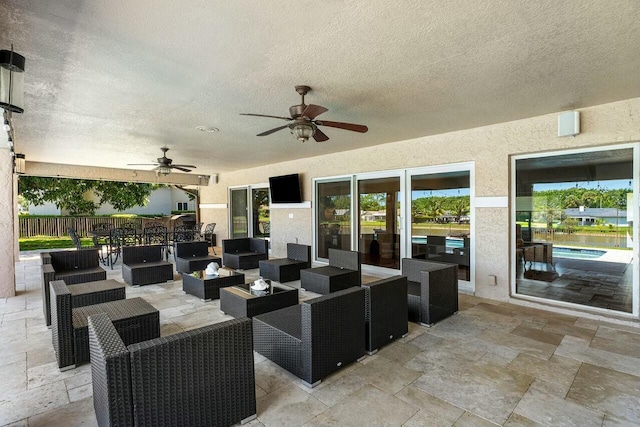view of patio / terrace featuring outdoor dining space, an outdoor hangout area, fence, and ceiling fan