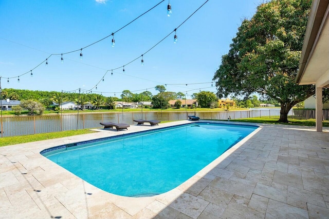 view of swimming pool with a fenced backyard, a water view, a patio, and a fenced in pool
