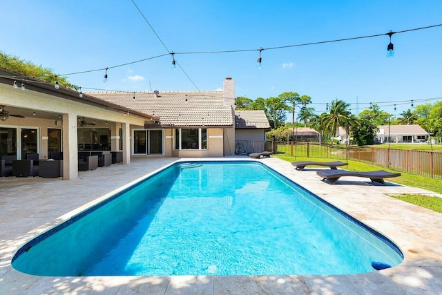 view of pool with fence, ceiling fan, and a patio area