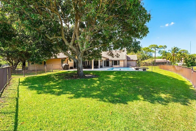 view of yard with a patio, a fenced in pool, and a fenced backyard