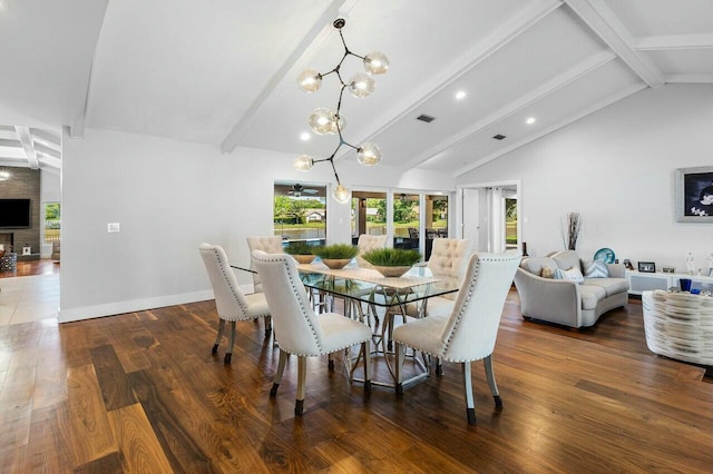 dining area featuring baseboards, visible vents, wood finished floors, and beamed ceiling