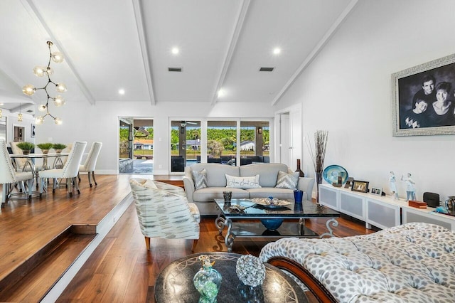 living area with baseboards, visible vents, beamed ceiling, and wood finished floors