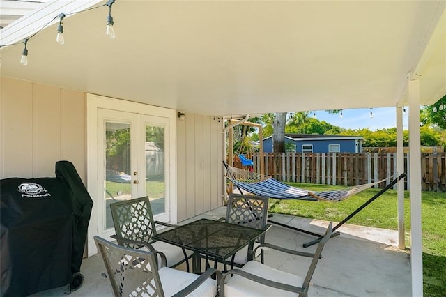 view of patio / terrace with french doors, area for grilling, and fence