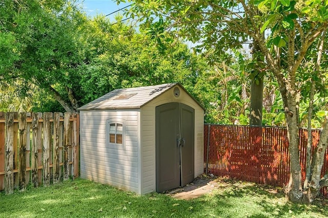 view of shed with a fenced backyard