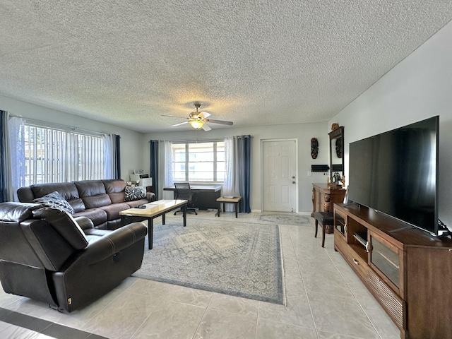 living area featuring a textured ceiling and a ceiling fan