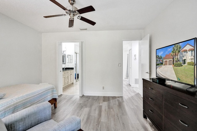 bedroom with visible vents, baseboards, a ceiling fan, and light wood finished floors