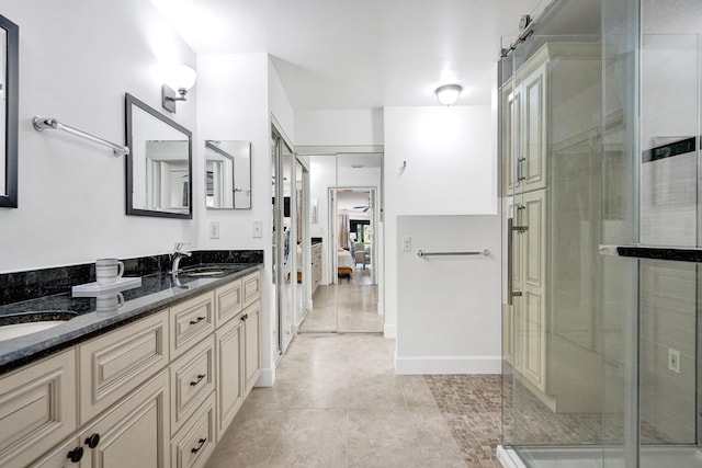 full bathroom with a sink, ensuite bathroom, double vanity, and a shower stall