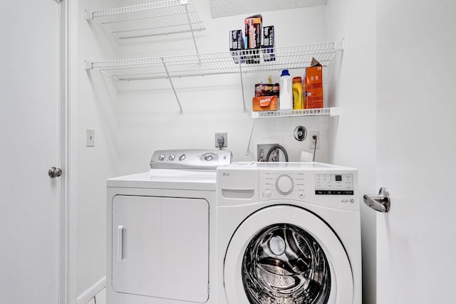 clothes washing area with laundry area and separate washer and dryer