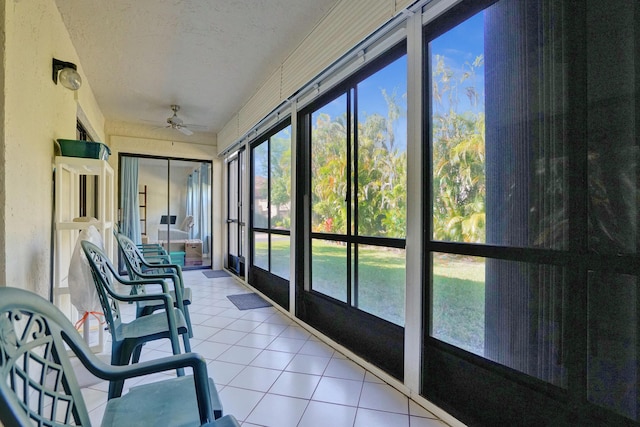 sunroom featuring a ceiling fan