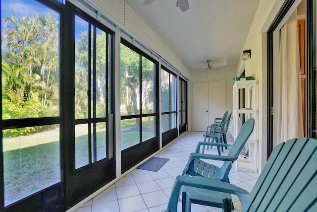 sunroom / solarium with a ceiling fan and a wealth of natural light