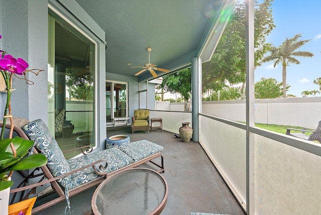 sunroom / solarium with a ceiling fan