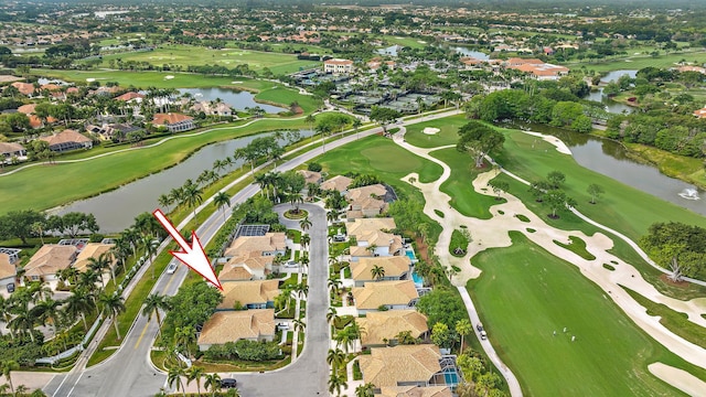 aerial view with view of golf course, a residential view, and a water view