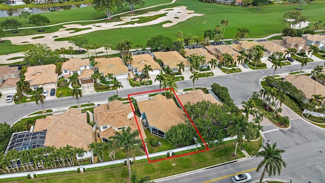 aerial view featuring view of golf course, a residential view, and a water view