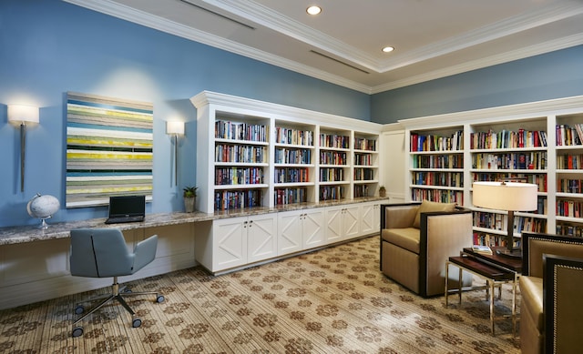 office with built in desk, recessed lighting, ornamental molding, light carpet, and bookshelves