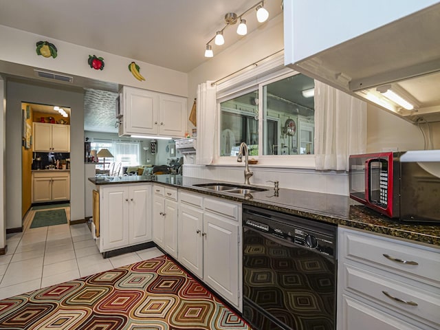 kitchen featuring visible vents, white cabinetry, dark stone counters, a sink, and dishwasher