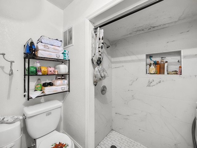 full bath with toilet, a stall shower, and visible vents