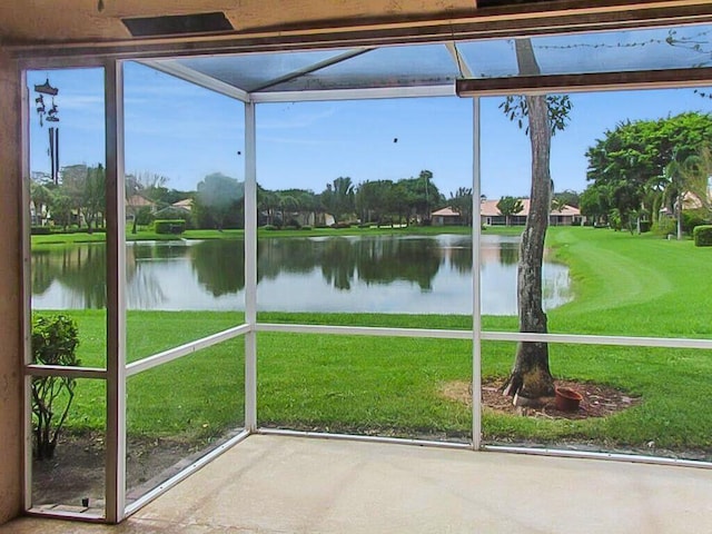 unfurnished sunroom with a water view