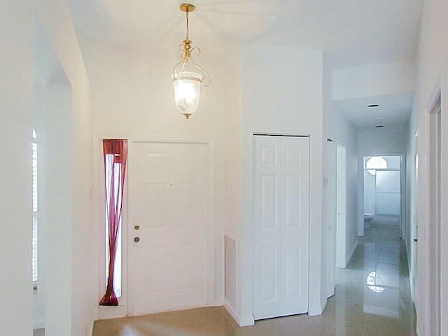 foyer entrance featuring visible vents