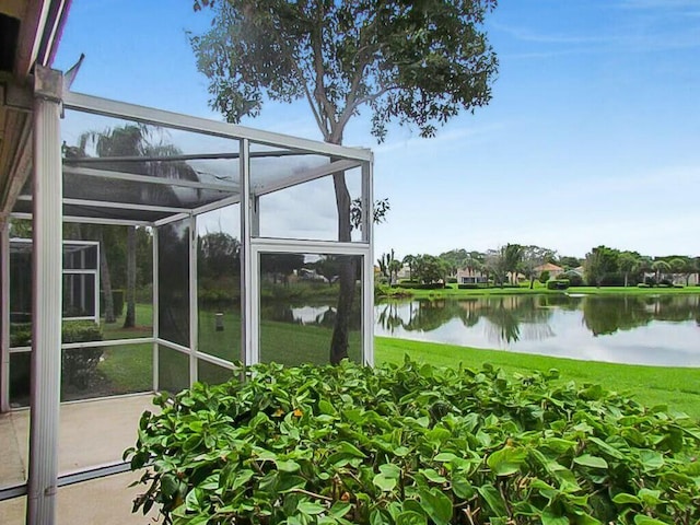 unfurnished sunroom featuring a water view