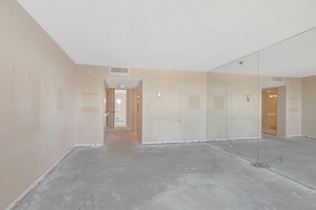 4545 N Ocean Blvd Unit 10C, Boca Raton, FL 33431 - unfurnished room with concrete flooring, baseboards, and a textured ceiling