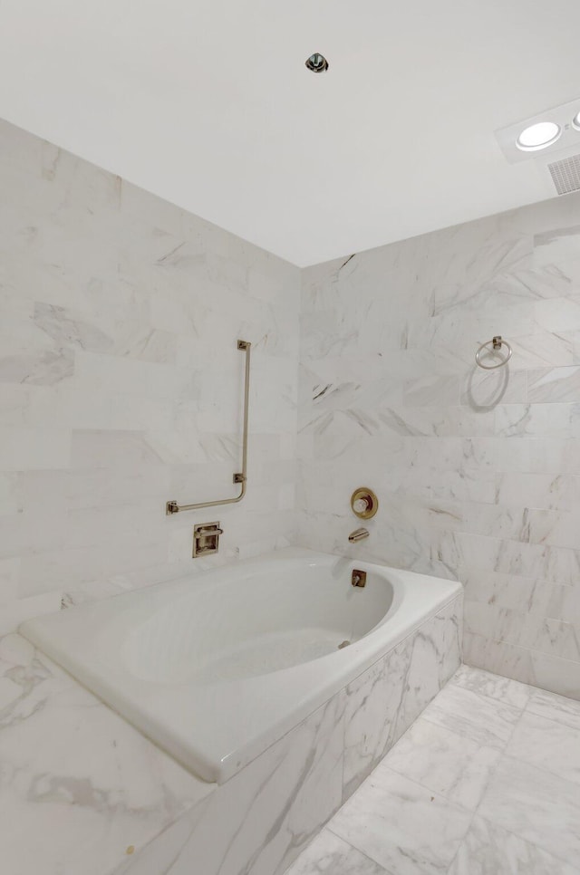 4545 N Ocean Blvd Unit 10C, Boca Raton, FL 33431 - full bath featuring a tub with marble appearance, marble finish flooring, and tile walls