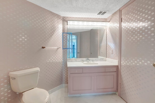 4545 N Ocean Blvd Unit 10C, Boca Raton, FL 33431 - bathroom with wallpapered walls, toilet, vanity, and a textured ceiling