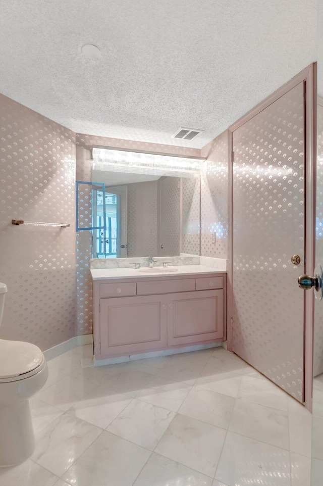 4545 N Ocean Blvd Unit 10C, Boca Raton, FL 33431 - bathroom with vanity, toilet, a textured ceiling, and wallpapered walls