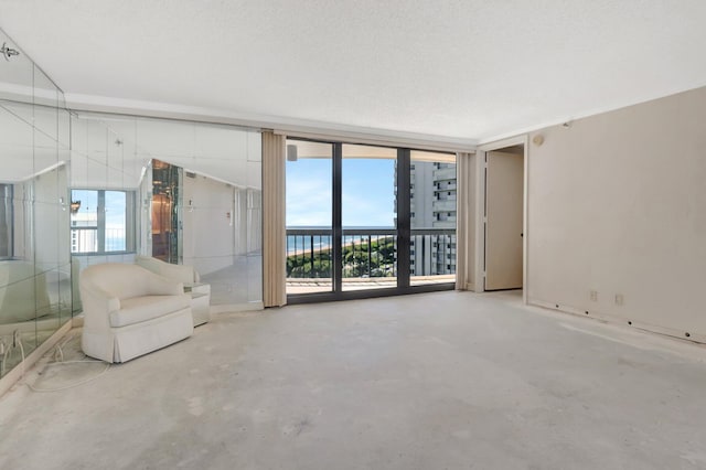 4545 N Ocean Blvd Unit 10C, Boca Raton, FL 33431 - unfurnished living room featuring unfinished concrete floors and plenty of natural light