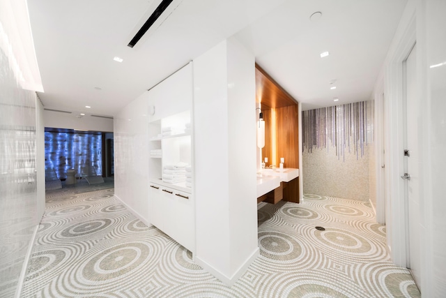 hall with light tile patterned floors and recessed lighting