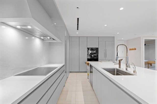 kitchen featuring a sink, light countertops, custom exhaust hood, black appliances, and modern cabinets