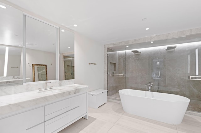 bathroom with recessed lighting, a stall shower, vanity, and a freestanding tub