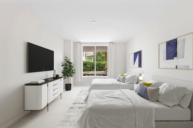 bedroom with light tile patterned flooring and baseboards