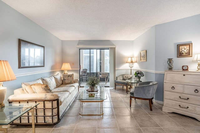 living area with tile patterned floors and a textured ceiling