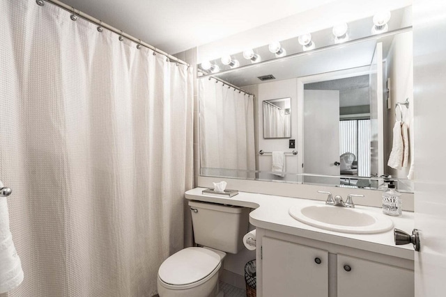 bathroom with vanity, toilet, and visible vents