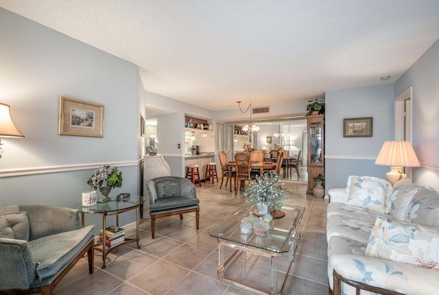 tiled living room with visible vents and a textured ceiling