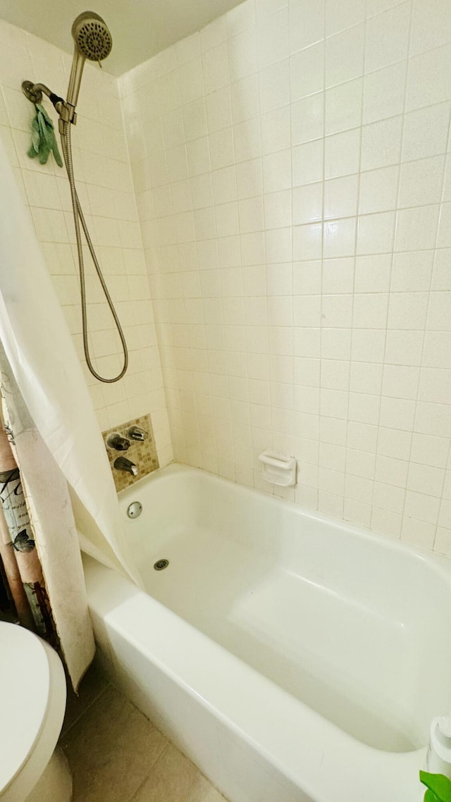 full bathroom with tile patterned floors, toilet, and shower / bath combination with curtain