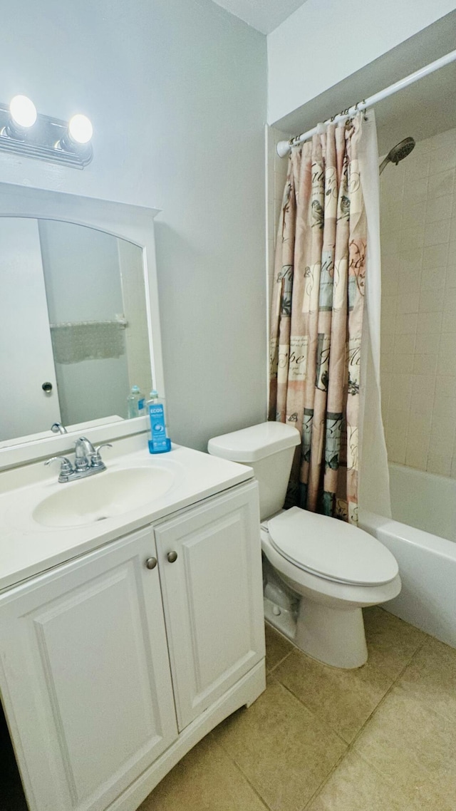 full bath featuring tile patterned floors, shower / bath combo with shower curtain, toilet, and vanity