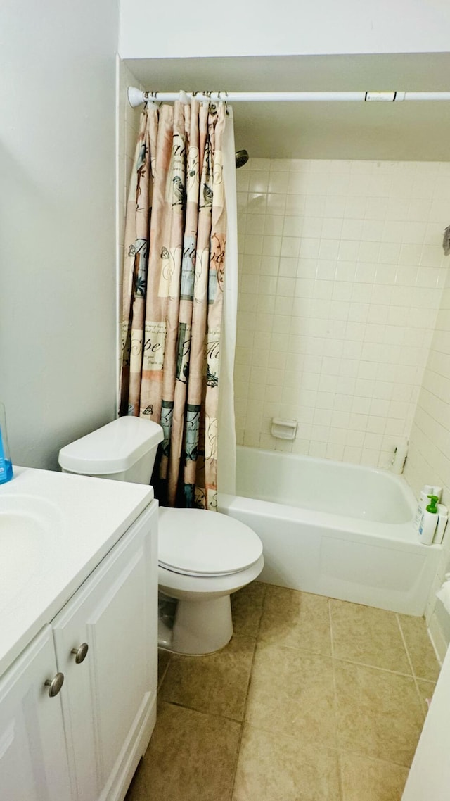 bathroom featuring vanity, tile patterned floors, shower / tub combo, and toilet