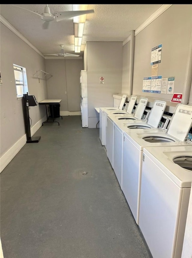 shared laundry area with baseboards, a textured ceiling, ornamental molding, and washing machine and clothes dryer