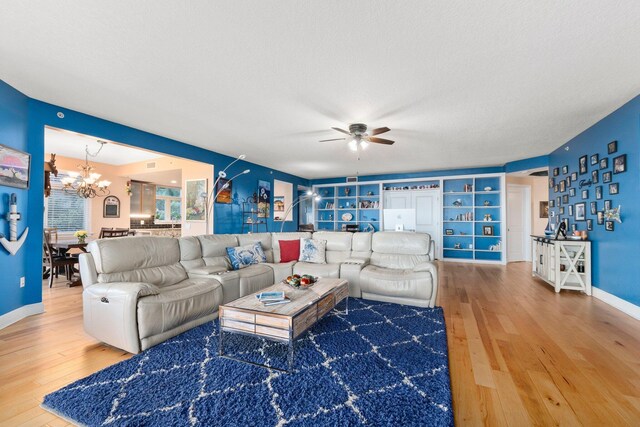 309 E Ocean Ave Unit 103, Lantana, FL 33462 - living room featuring baseboards, a textured ceiling, ceiling fan with notable chandelier, and wood-type flooring