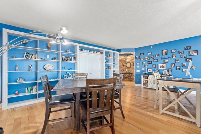 309 E Ocean Ave Unit 103, Lantana, FL 33462 - dining room with a textured ceiling, baseboards, and wood finished floors