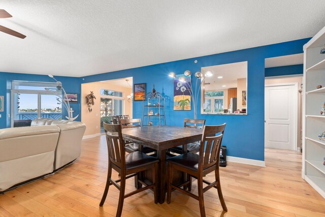 309 E Ocean Ave Unit 103, Lantana, FL 33462 - dining room featuring baseboards, a ceiling fan, and light wood finished floors