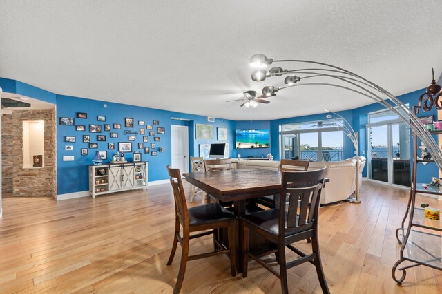 309 E Ocean Ave Unit 103, Lantana, FL 33462 - dining area featuring a textured ceiling, ceiling fan, baseboards, and light wood-type flooring
