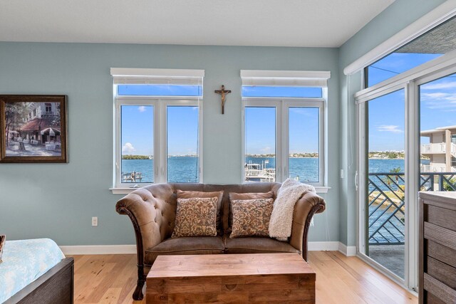 309 E Ocean Ave Unit 103, Lantana, FL 33462 - living room featuring light wood-style flooring, baseboards, and a water view