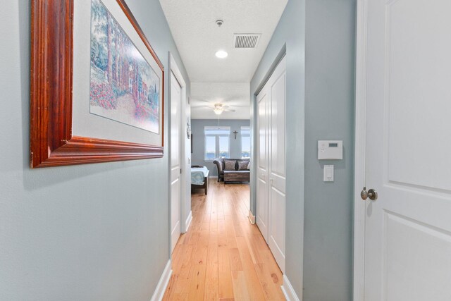 309 E Ocean Ave Unit 103, Lantana, FL 33462 - hallway featuring light wood-style flooring, baseboards, and visible vents